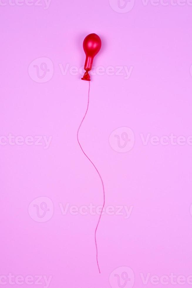 Red air balloon on red string photo