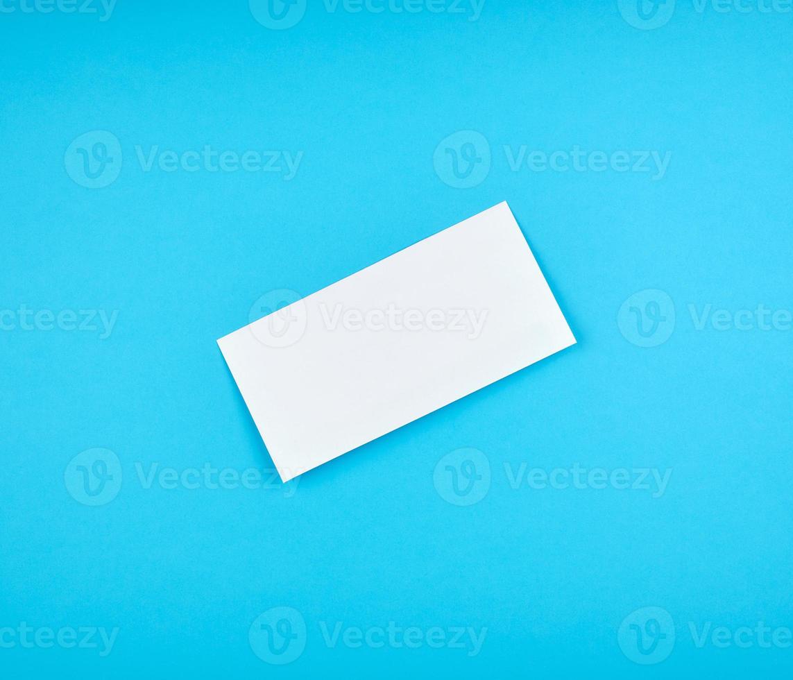 white rectangular paper envelope on a blue background photo