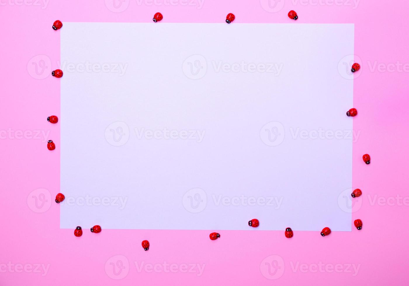 White sheet of paper on a pink surface, photo