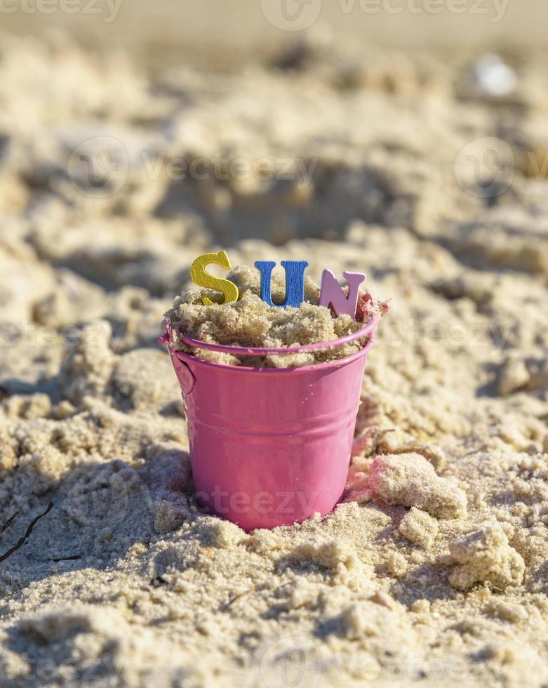 baby iron bucket filled with wooden colorful letters, inscription sun photo