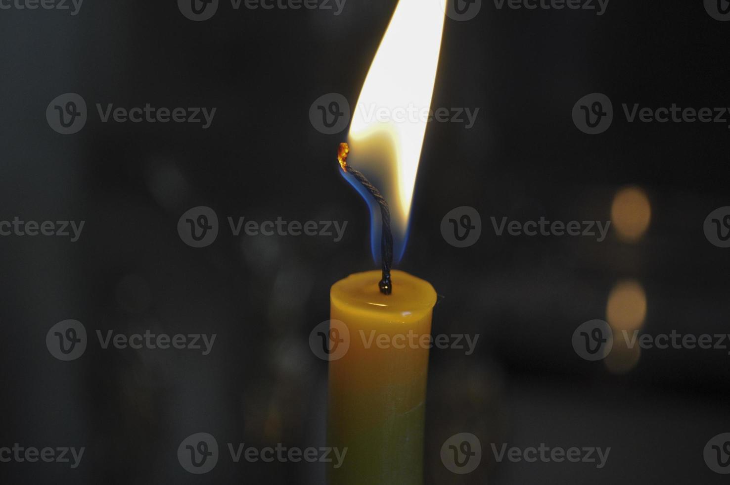 Lone yellow candle photo