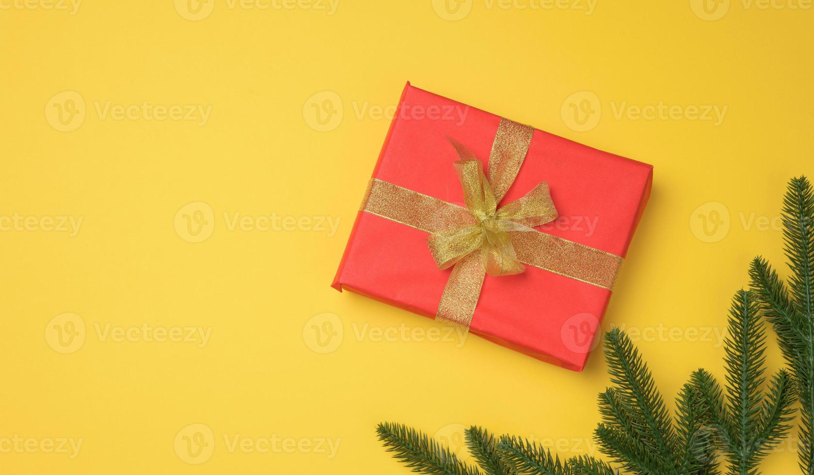 red gift box tied with ribbon on a gray background, top view. Festive backdrop photo