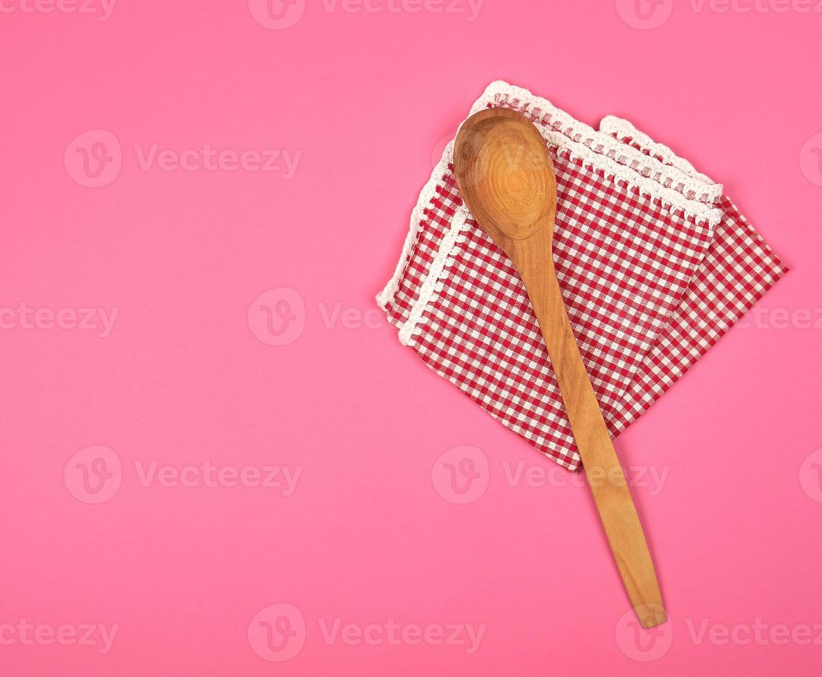 wooden spoon on a red kitchen towel photo