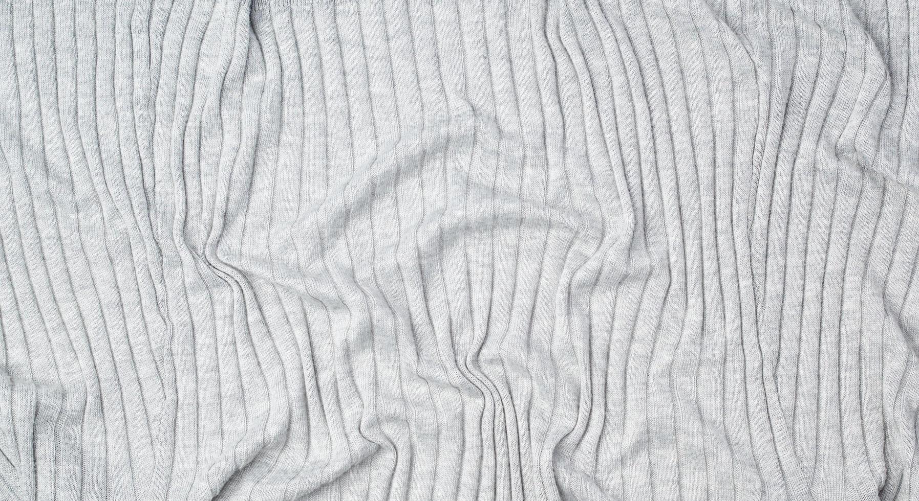fragment of gray knitted fabric, full frame, fabric for sweaters photo
