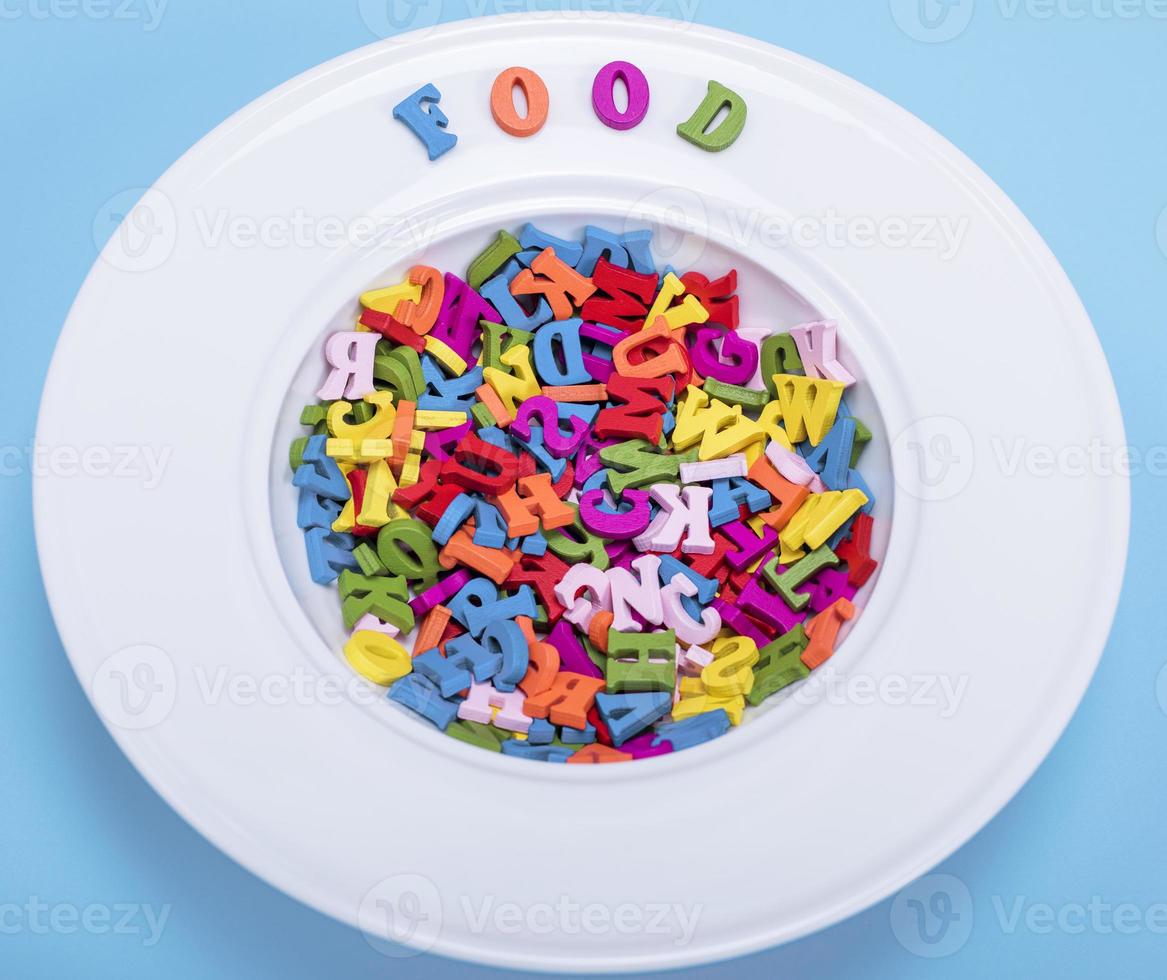 plate for soup full of multicolored wooden letters photo