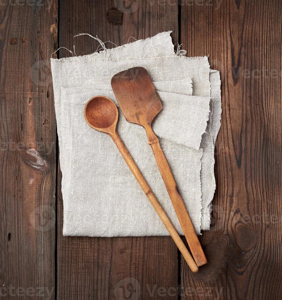 wooden old spoon and spatula on a gray linen napkin photo