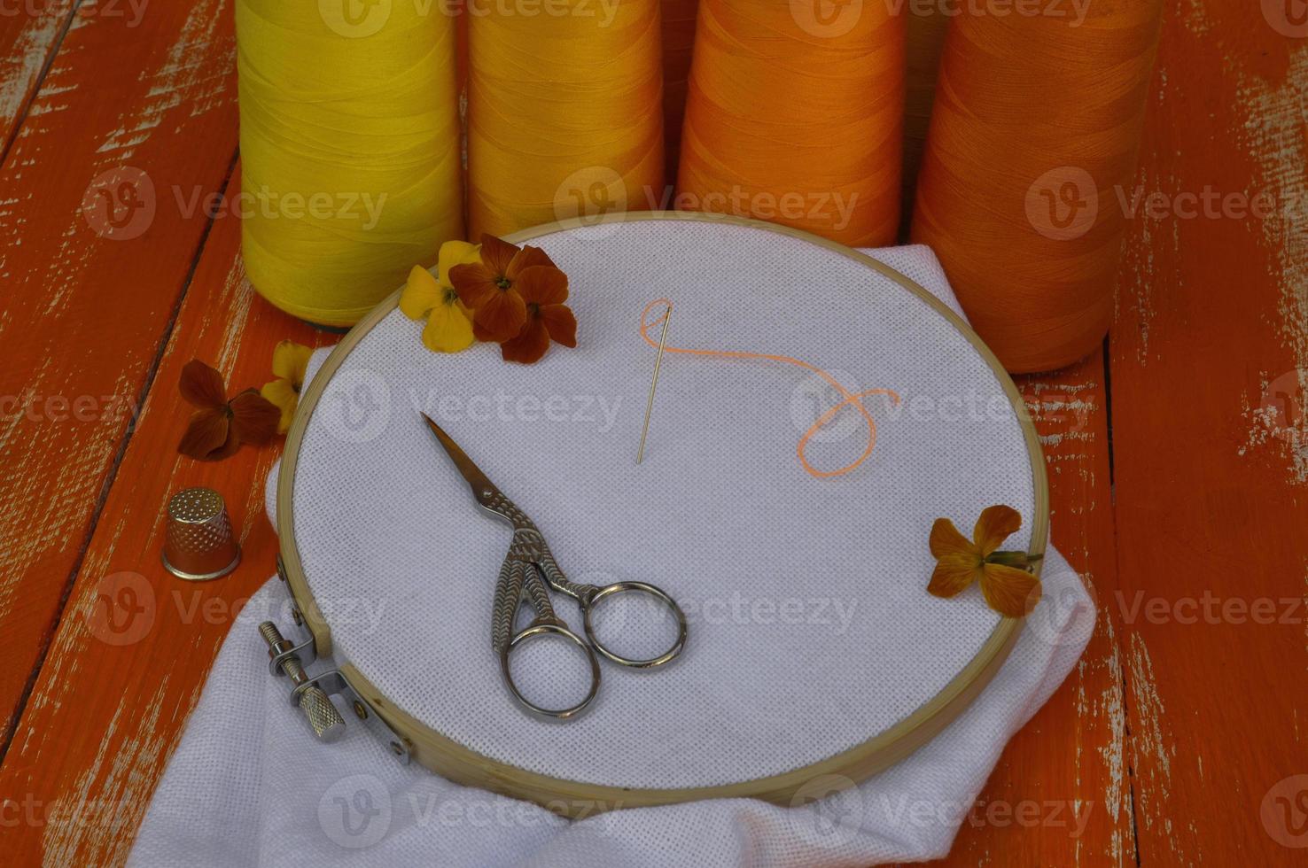 Items for needlework and embroidery in orange and yellow colors photo
