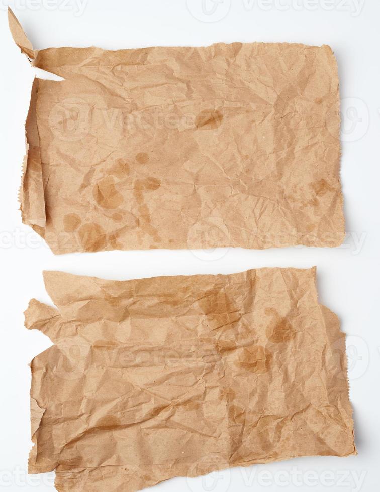 torn crumpled pieces of brown paper with grease stains photo