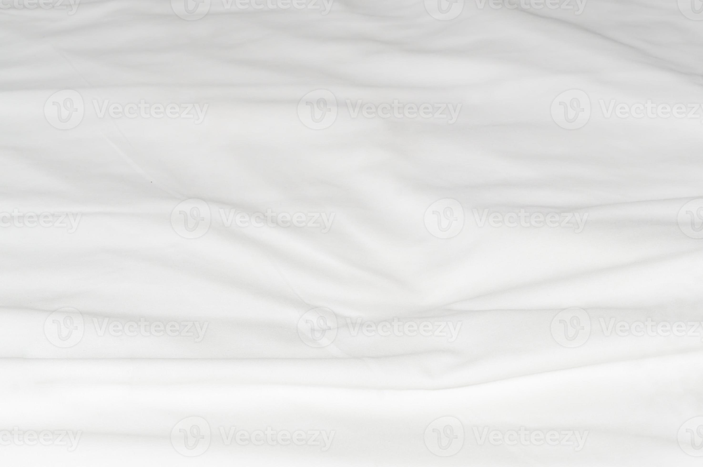 White crumpled or wrinkled bedding sheet or blanket with pattern after