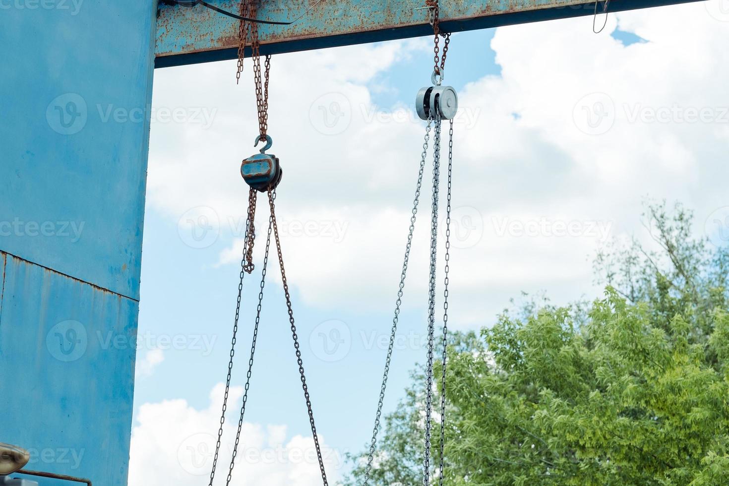 old iron structure with hook chains on the street photo