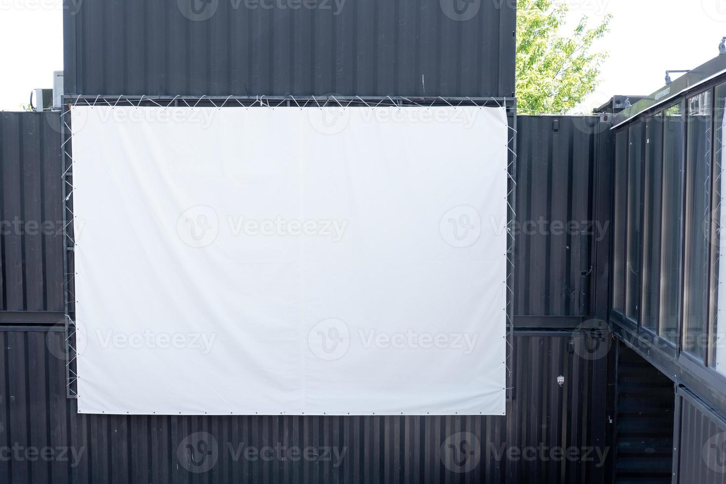 empty white screen for showing a movie, on the street photo