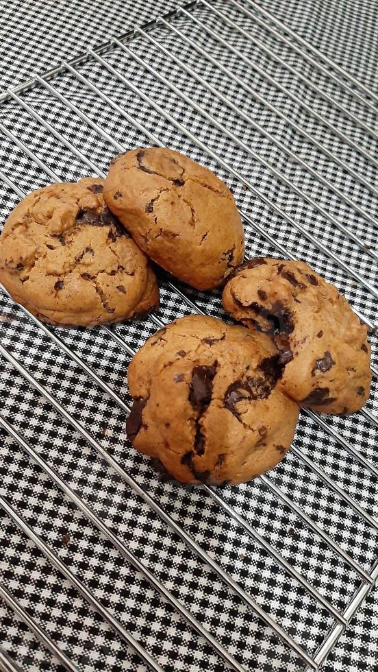 Chocolate chip cookies on a baking sheet ready for eat photo