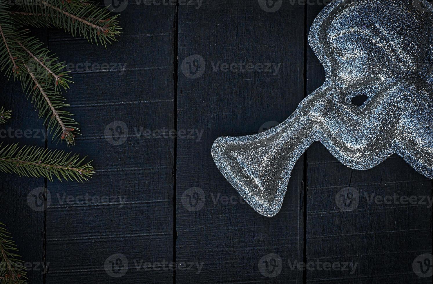brilliant figure of an angel with a trumpet on a black wooden background photo