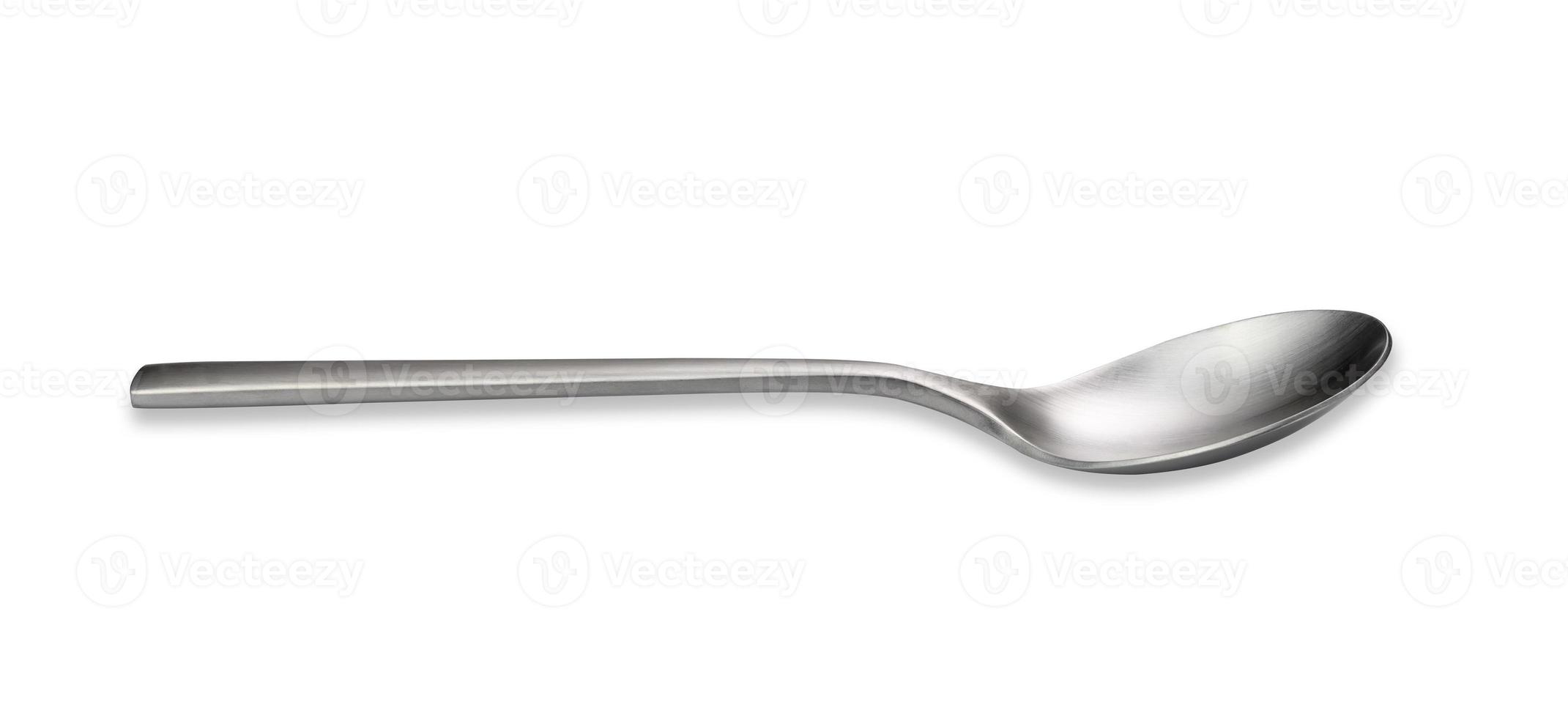 Empty metal spoon on a white isolated background. Brushed steel texture photo