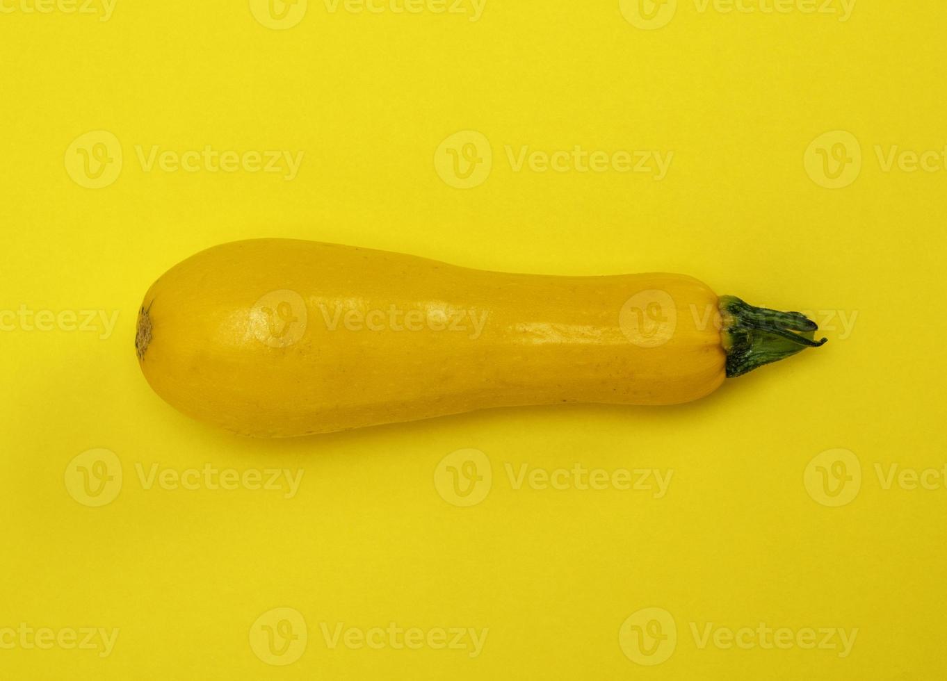 ripe yellow zucchini on a yellow background photo