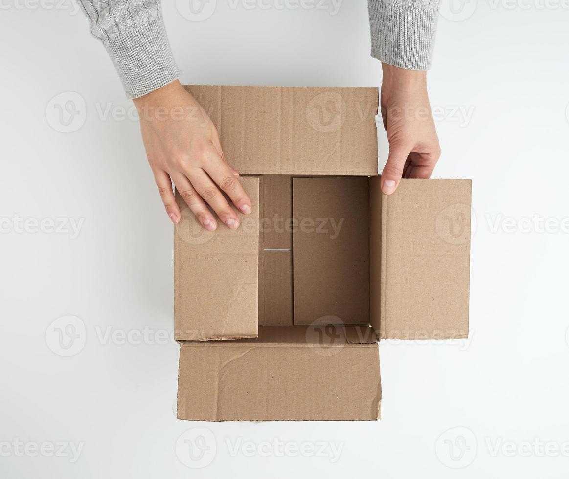 open empty square brown cardboard box for transportation and packaging of goods photo