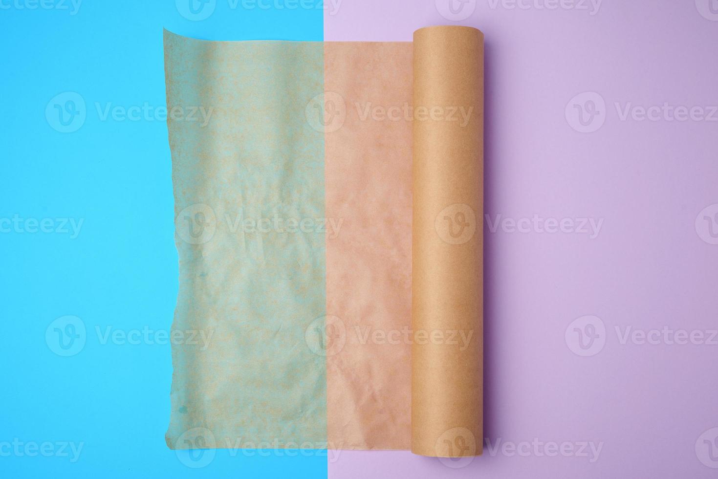 unwrapped a roll of brown parchment paper on a colored background photo