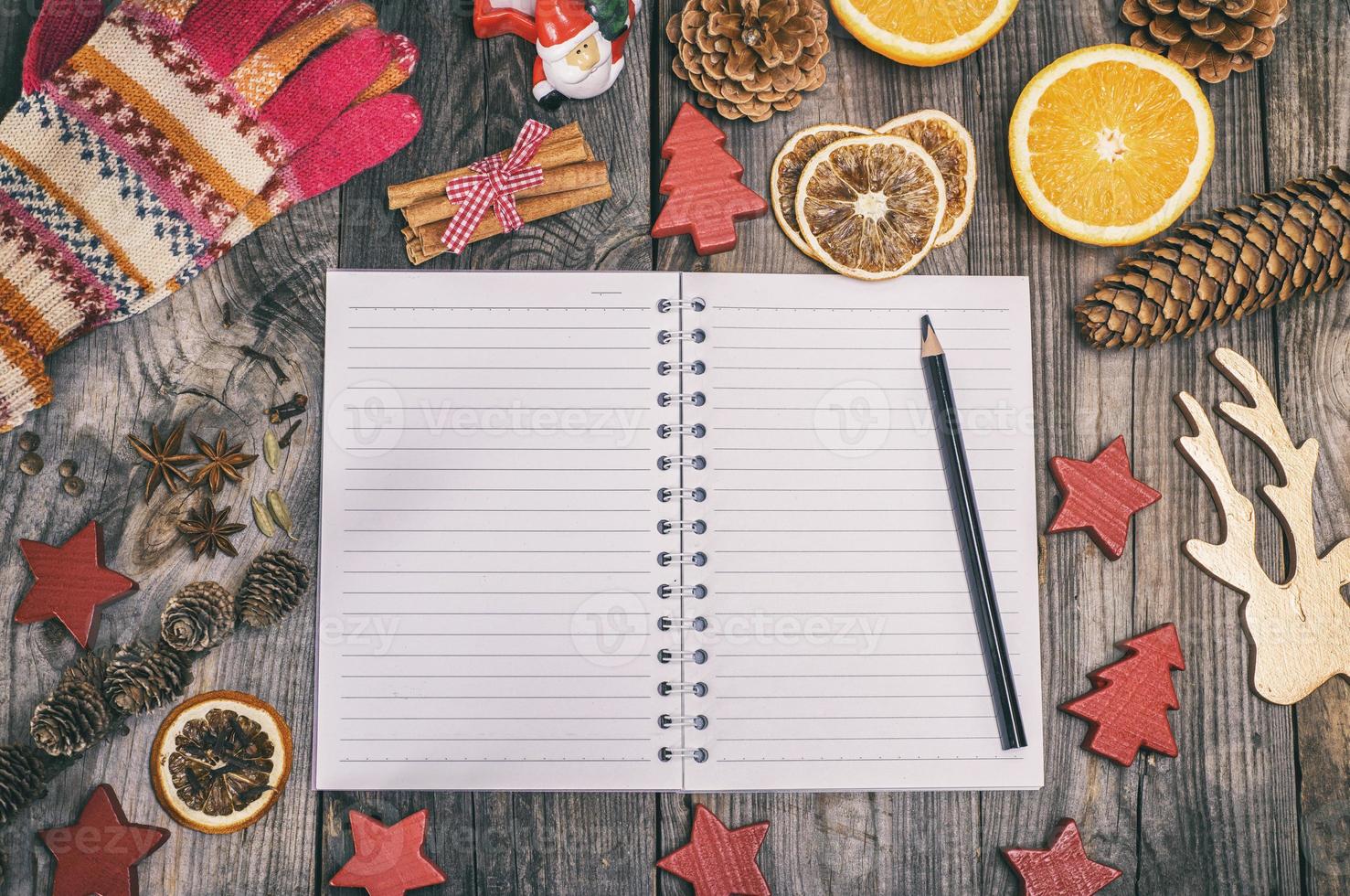 empty notebook in a line and a black pencil photo