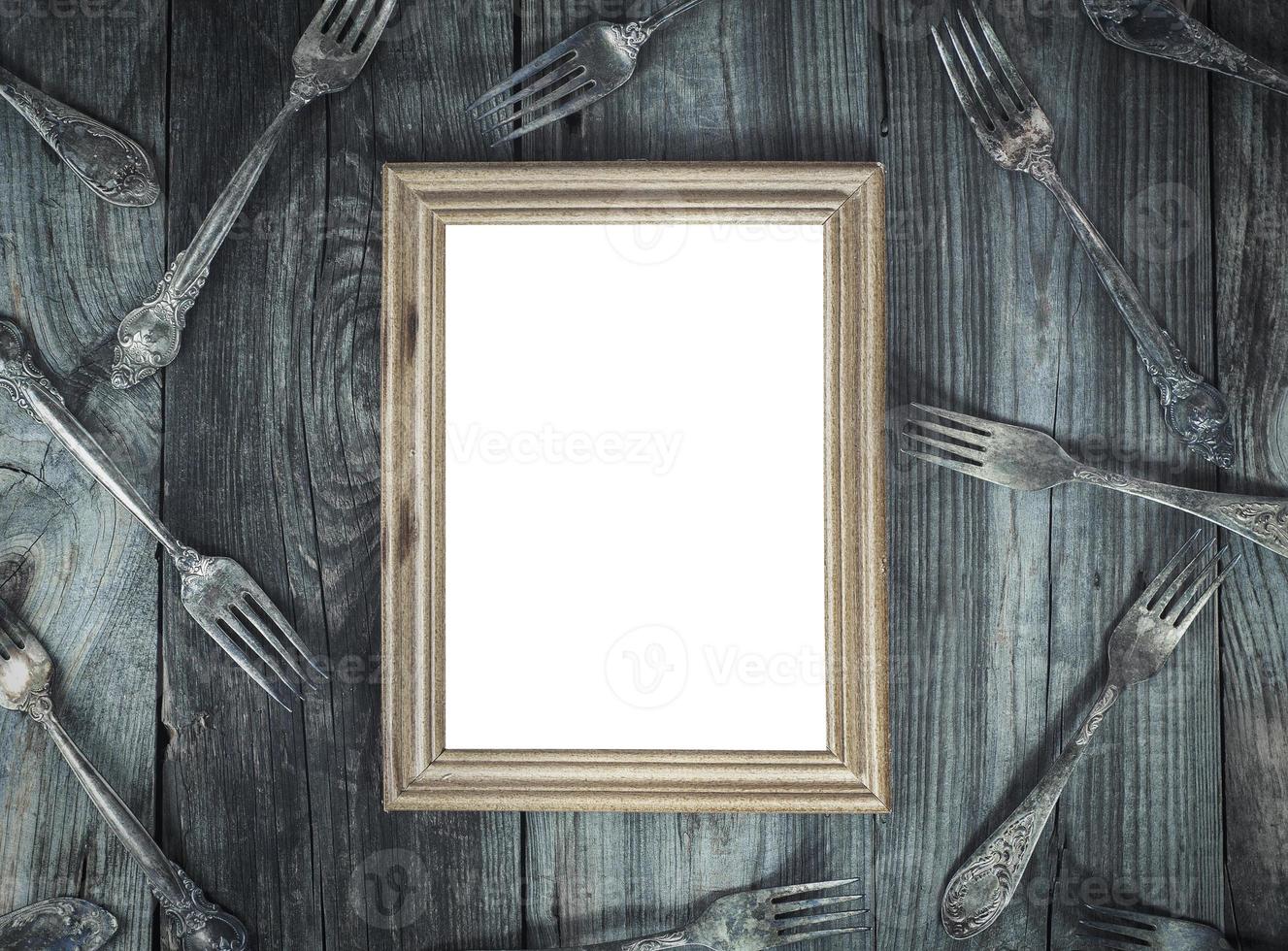 Empty wooden frame on the gray wooden surface photo