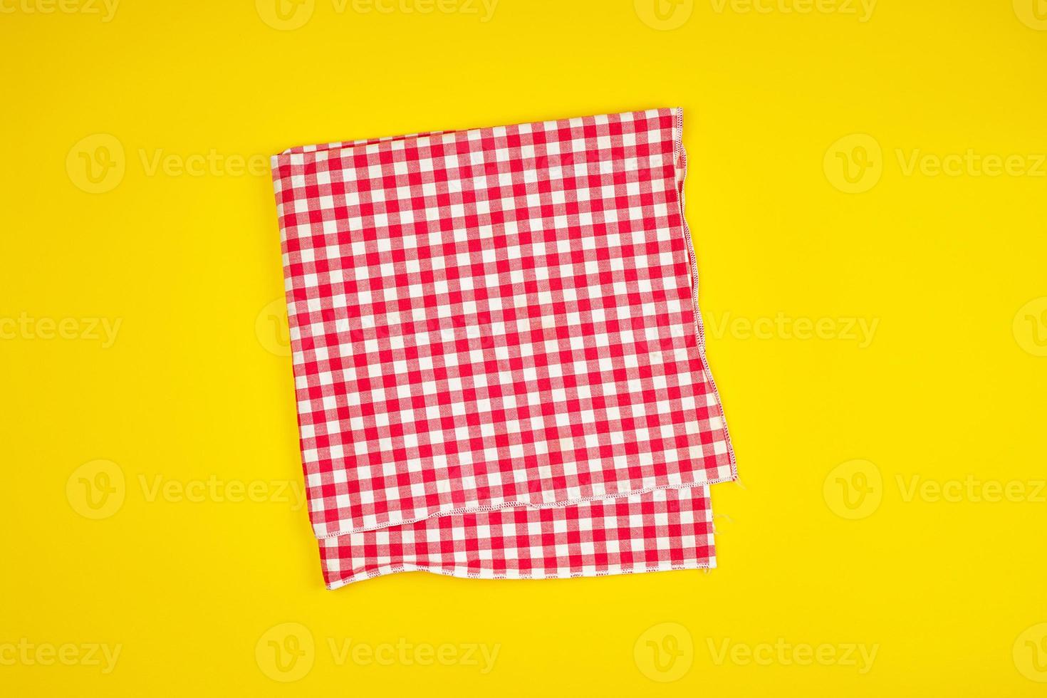 white red checkered kitchen towel on a yellow background photo