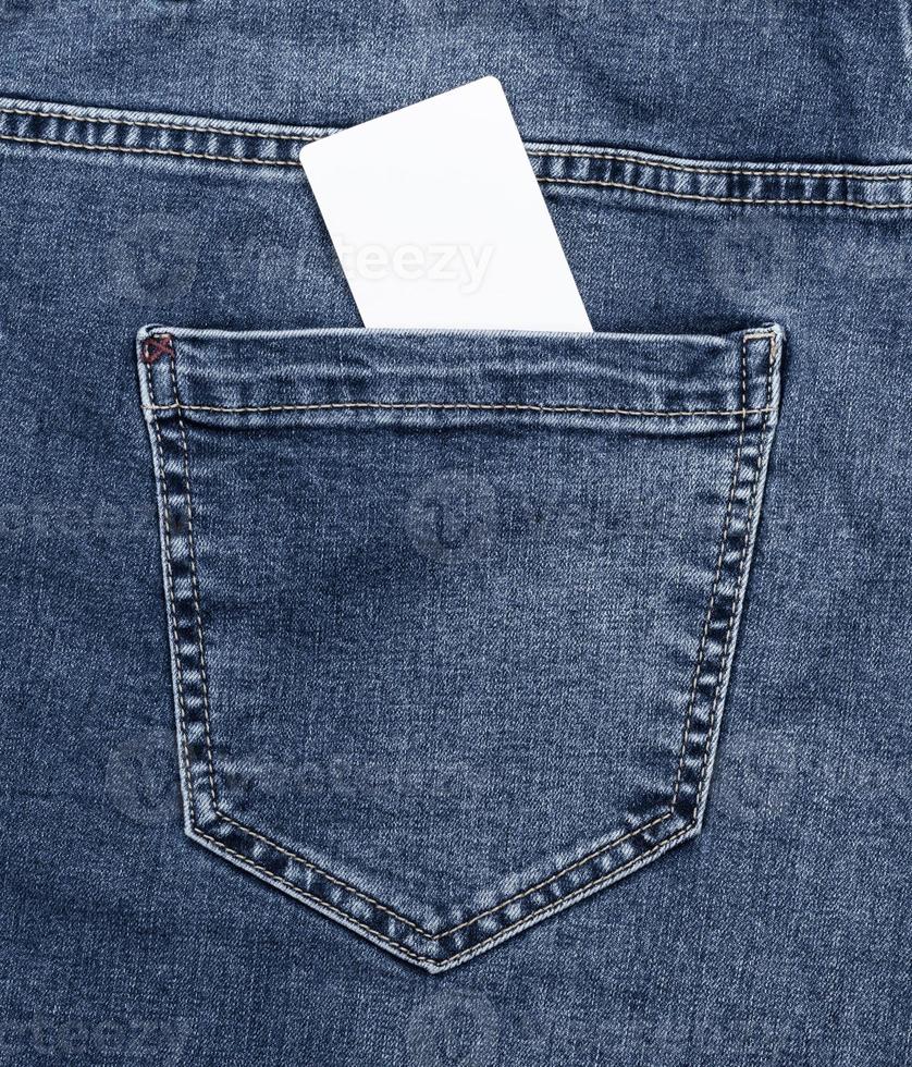 empty white paper card in the back pocket of blue jeans photo