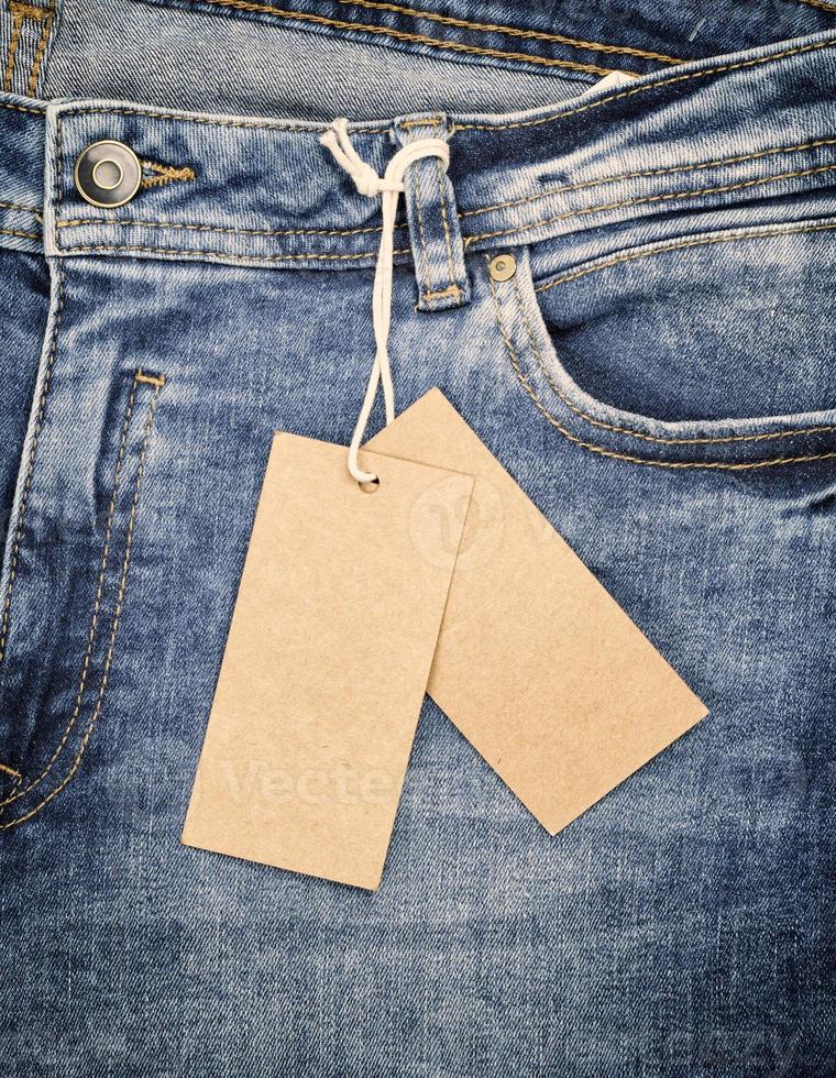 blue jeans with a brown paper tag on a rope photo