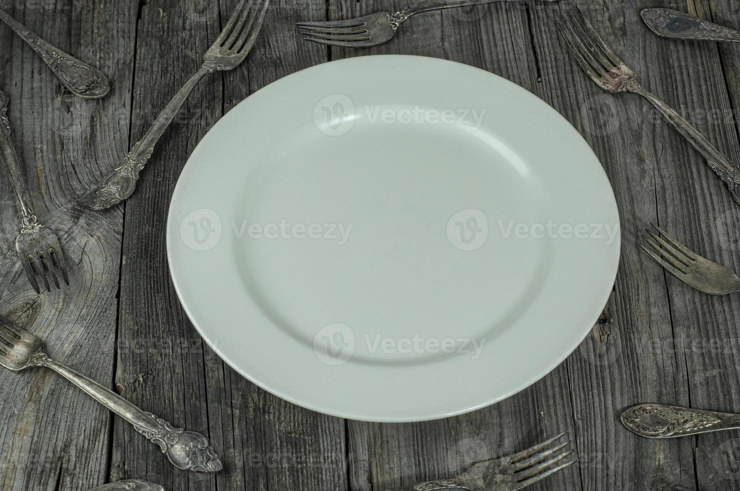 White empty plate on a gray wooden surface photo