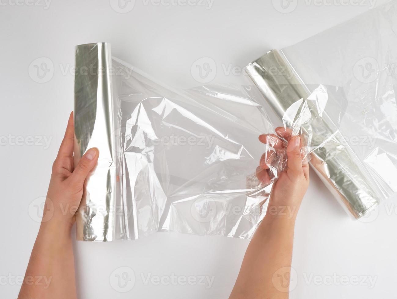 Plastic food wrap for baking products in the oven in women's hand photo