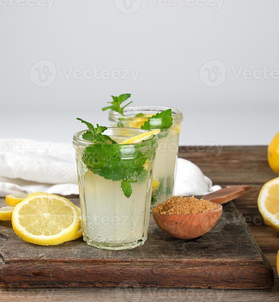 summer refreshing drink lemonade with lemons, mint leaves in a glass photo