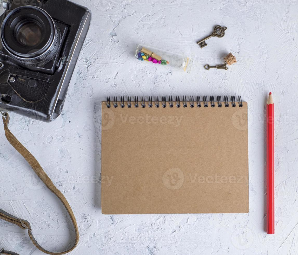 open blank notepad on an iron spring with brown sheets photo