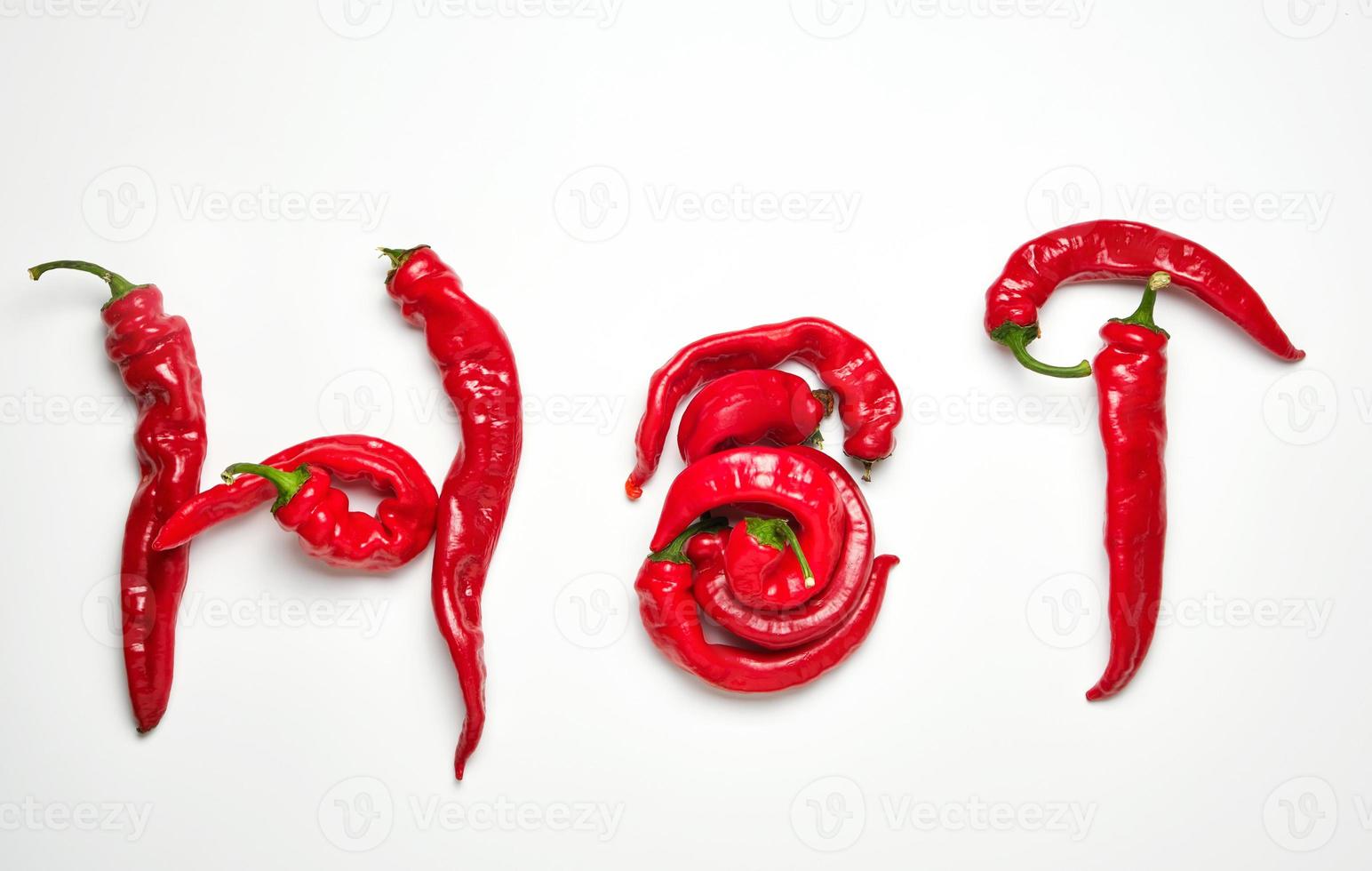 whole ripe red hot peppers on a white background photo