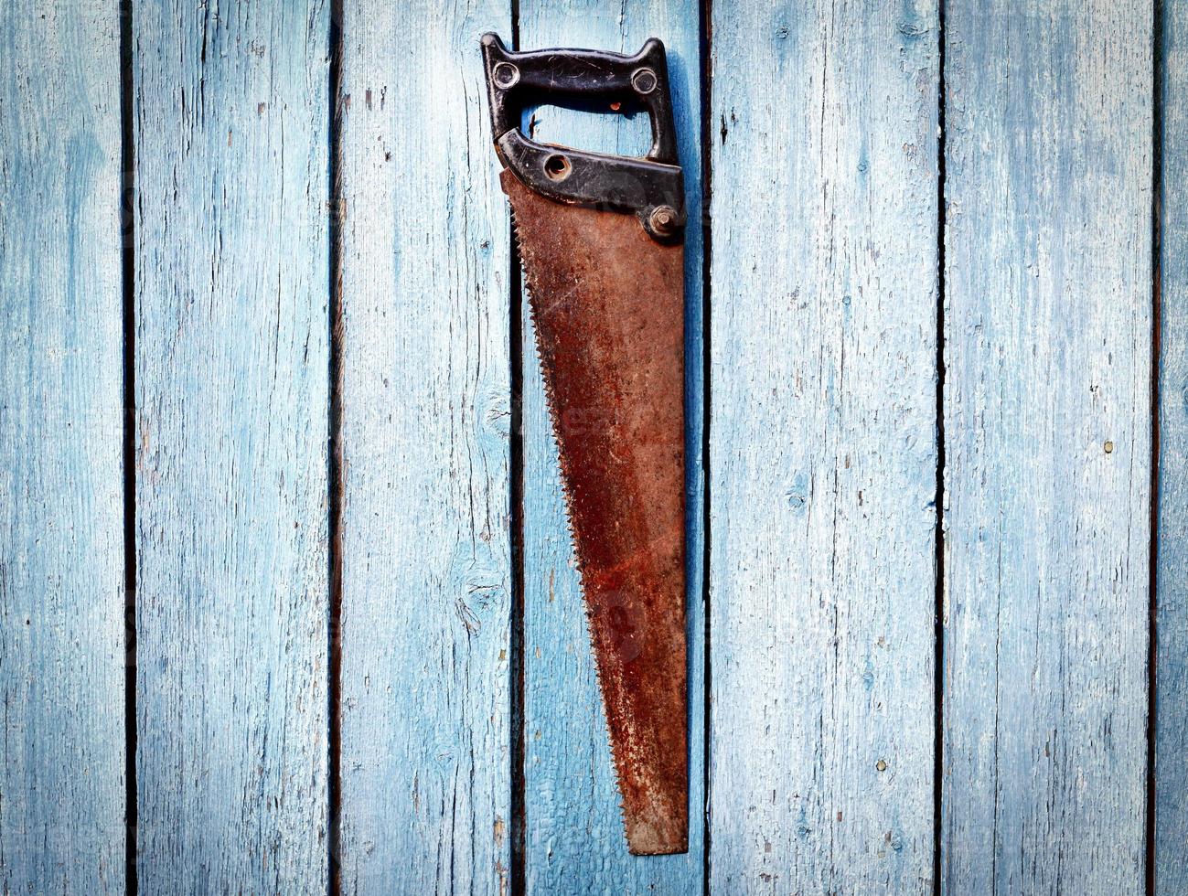 rusty metal hand saw photo