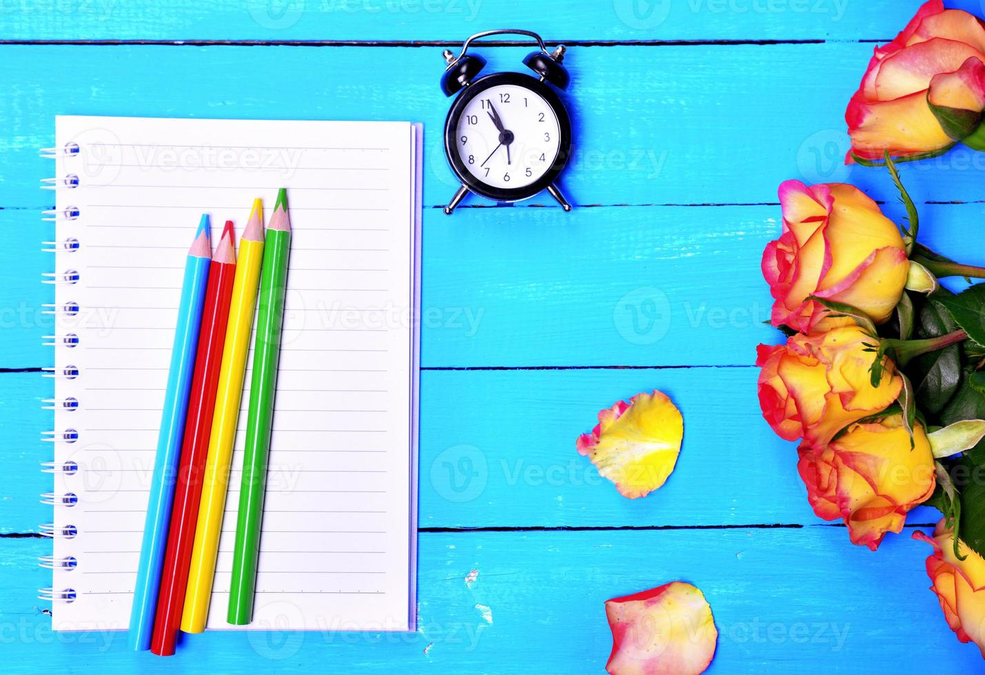 Empty notebook and colorful pencils photo
