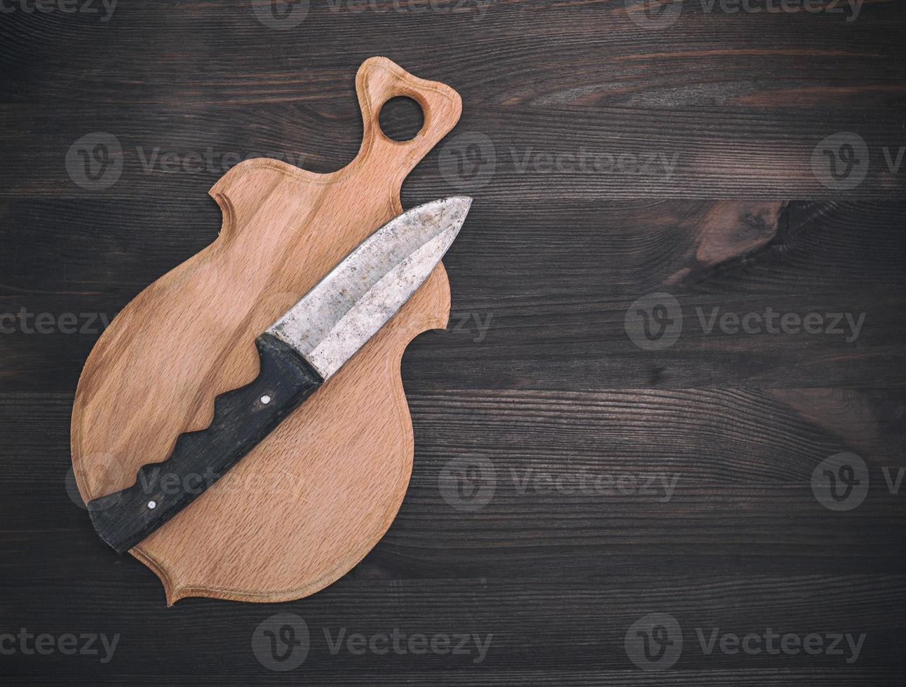 wooden cutting board and old knife photo