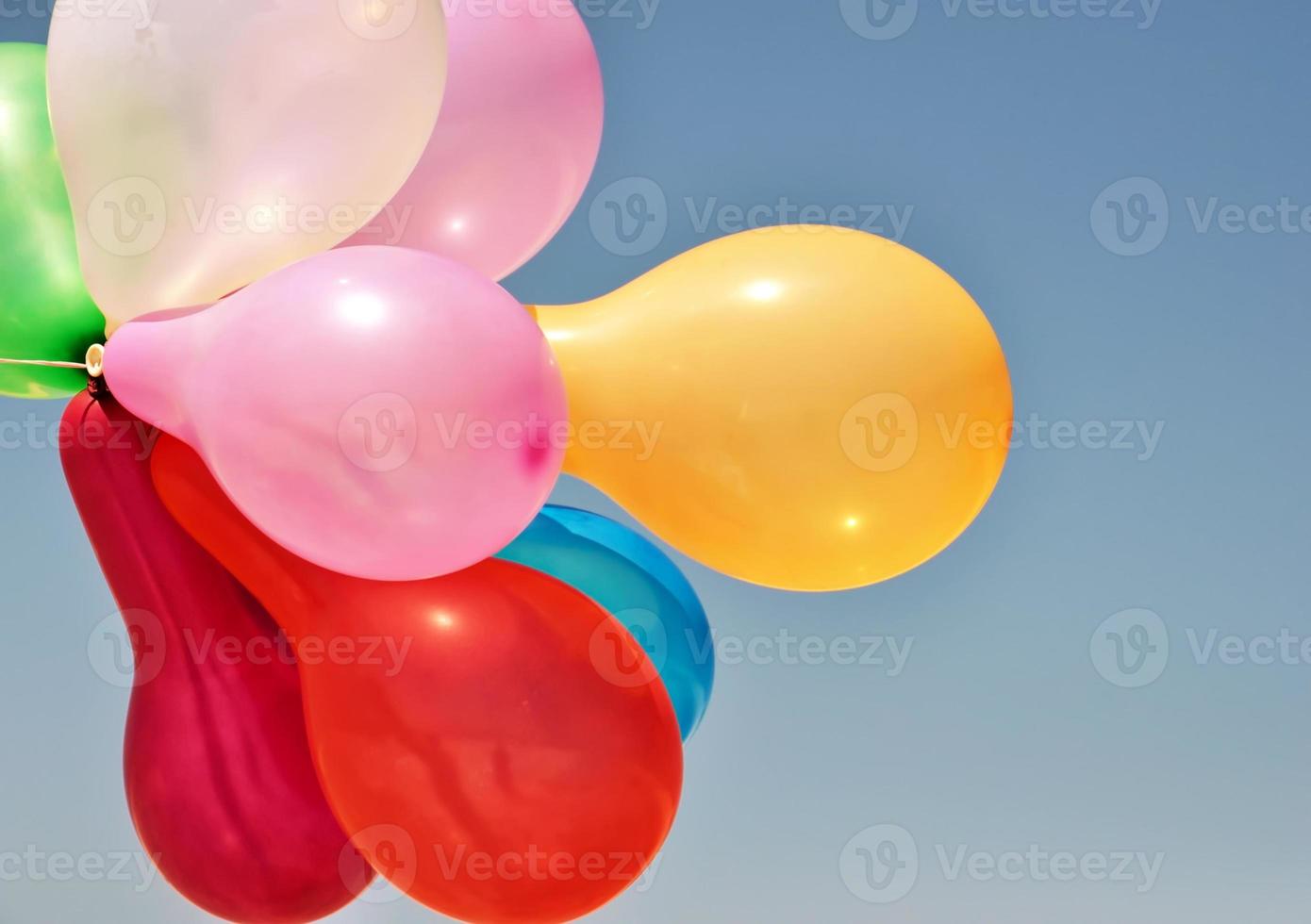 Multicolored balloons on a blue background photo