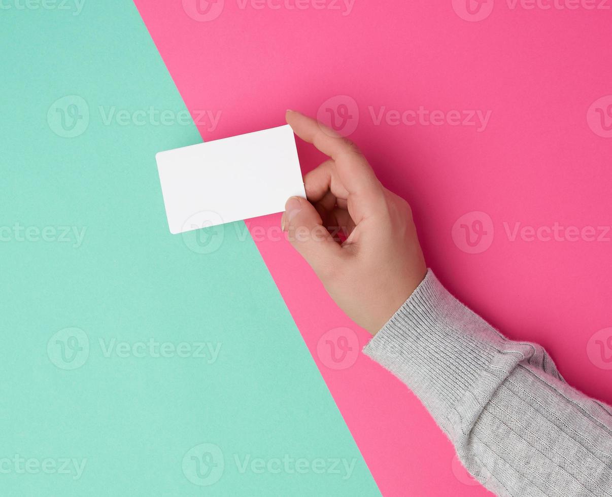female hand holding empty white paper business photo