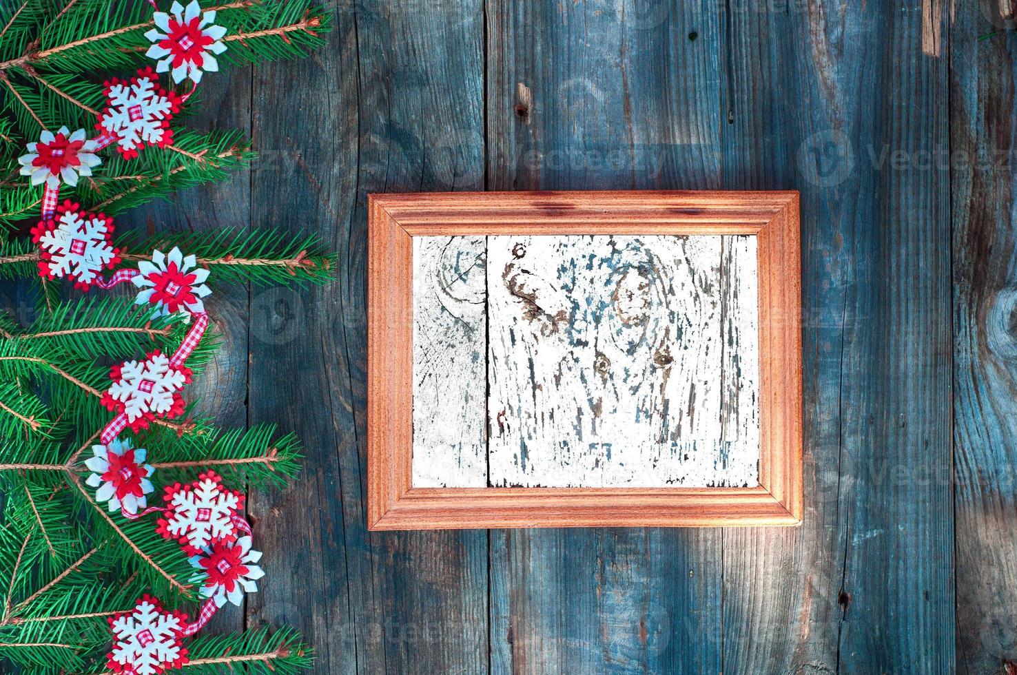 empty wooden frame for Christmas lettering decorated with fir branches photo