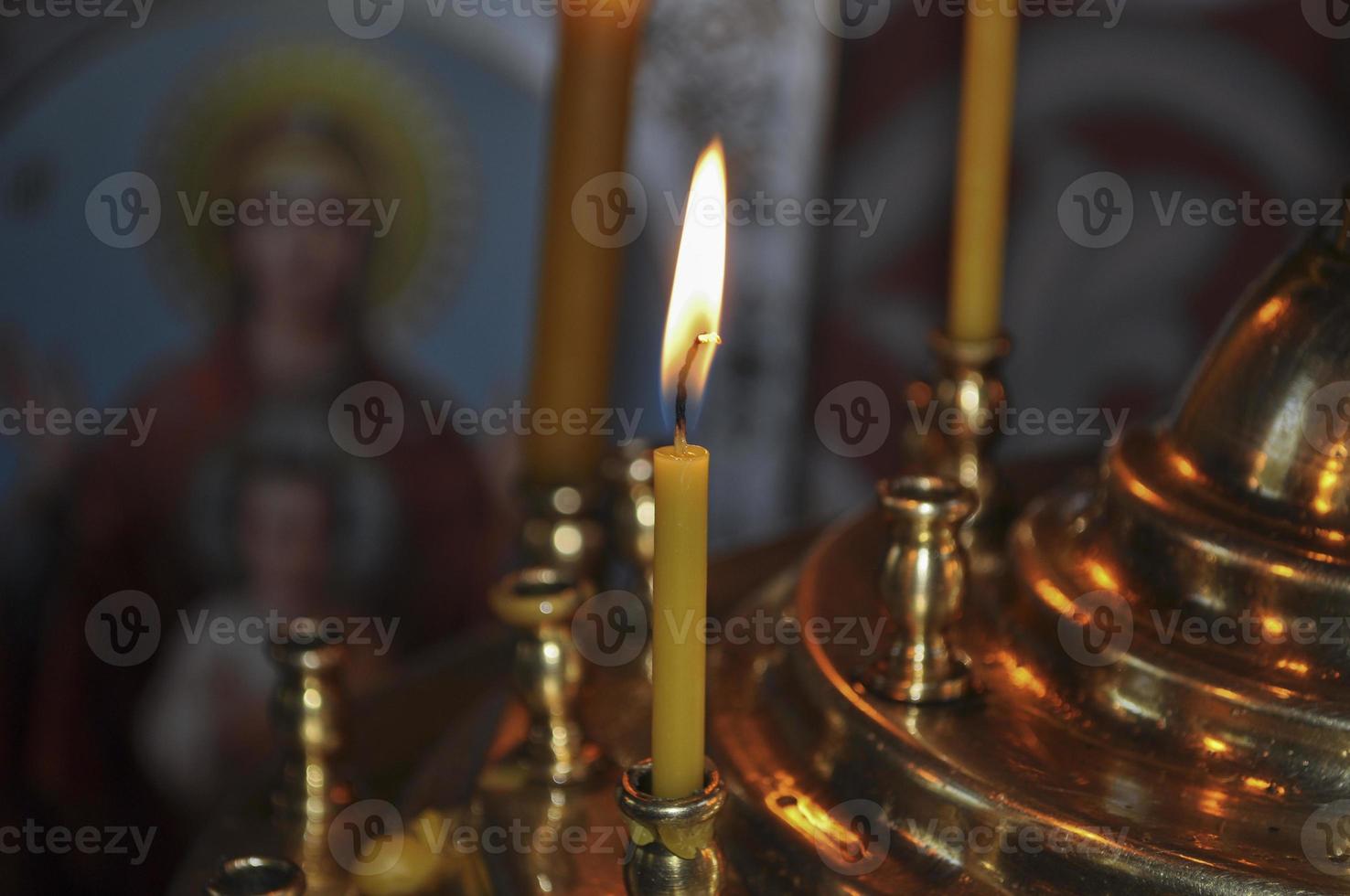 Burning candle in a candelabrum photo