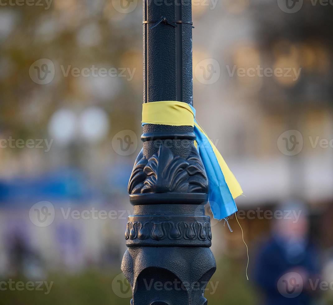 Blue and yellow silk ribbon tied on a metal tube. Ukrainian flag symbol, struggle for independence photo