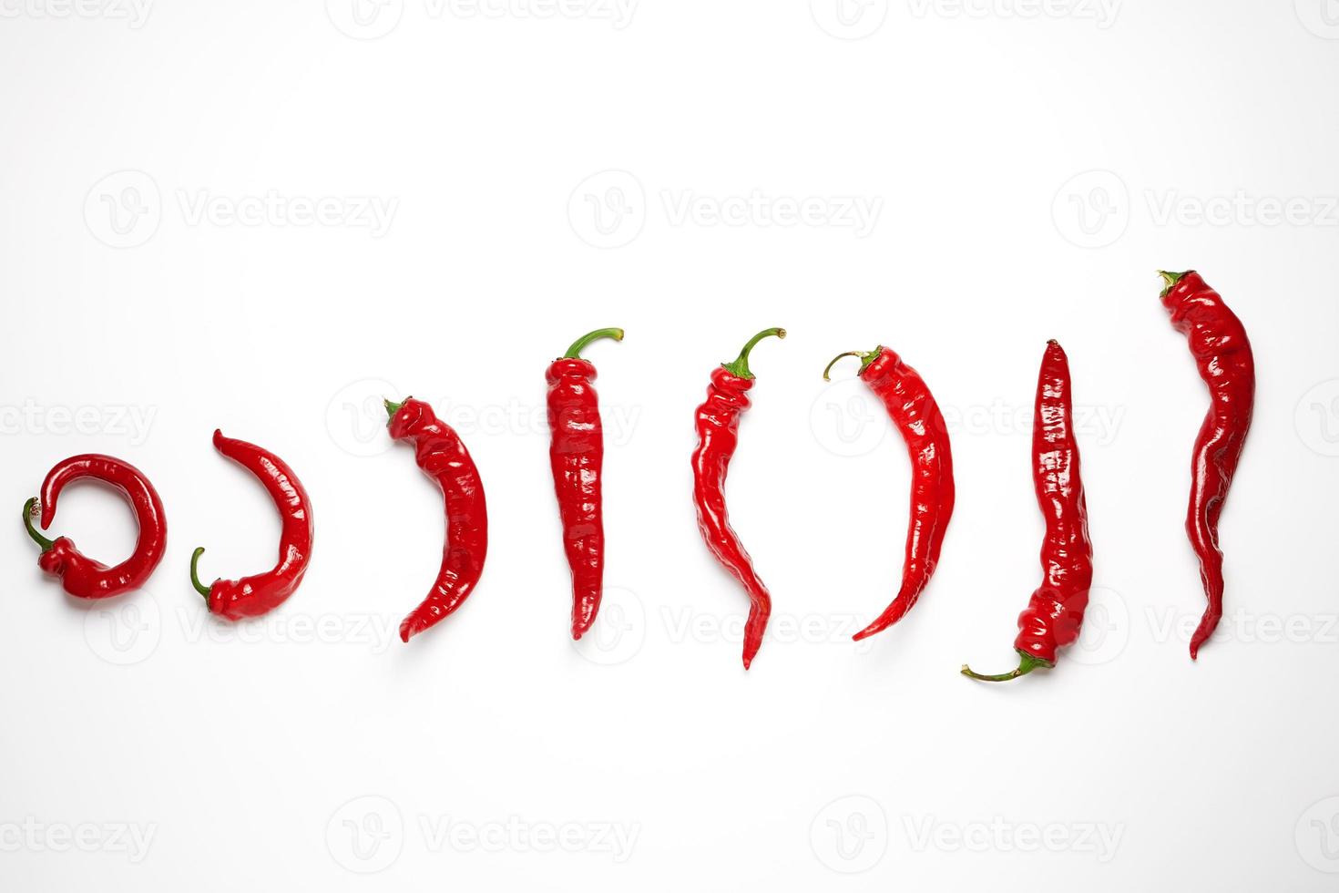 whole ripe red hot chili peppers on a white background photo