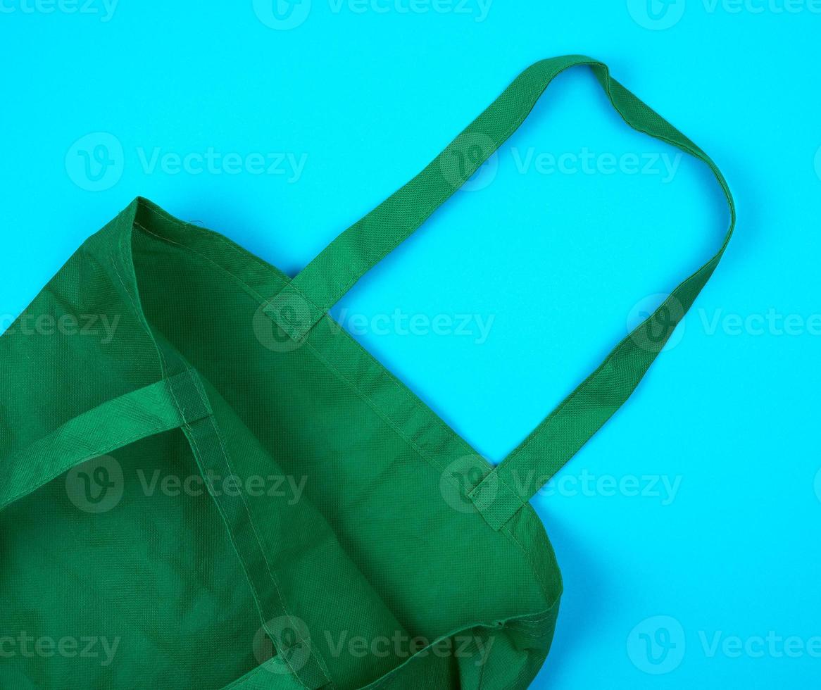 empty green ecological bag made of viscose with long handles photo