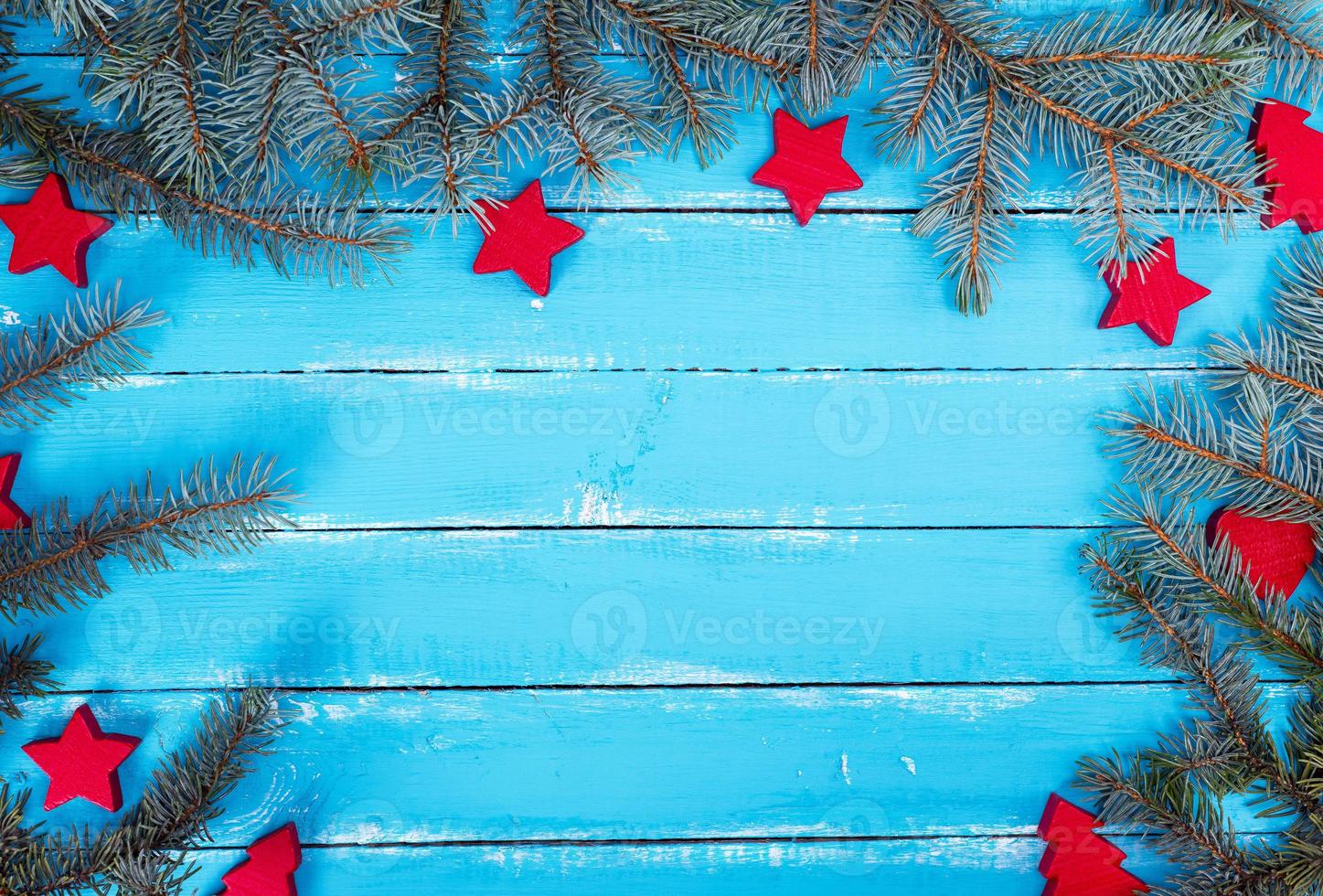 wooden background of parallel boards with green spruce branches photo