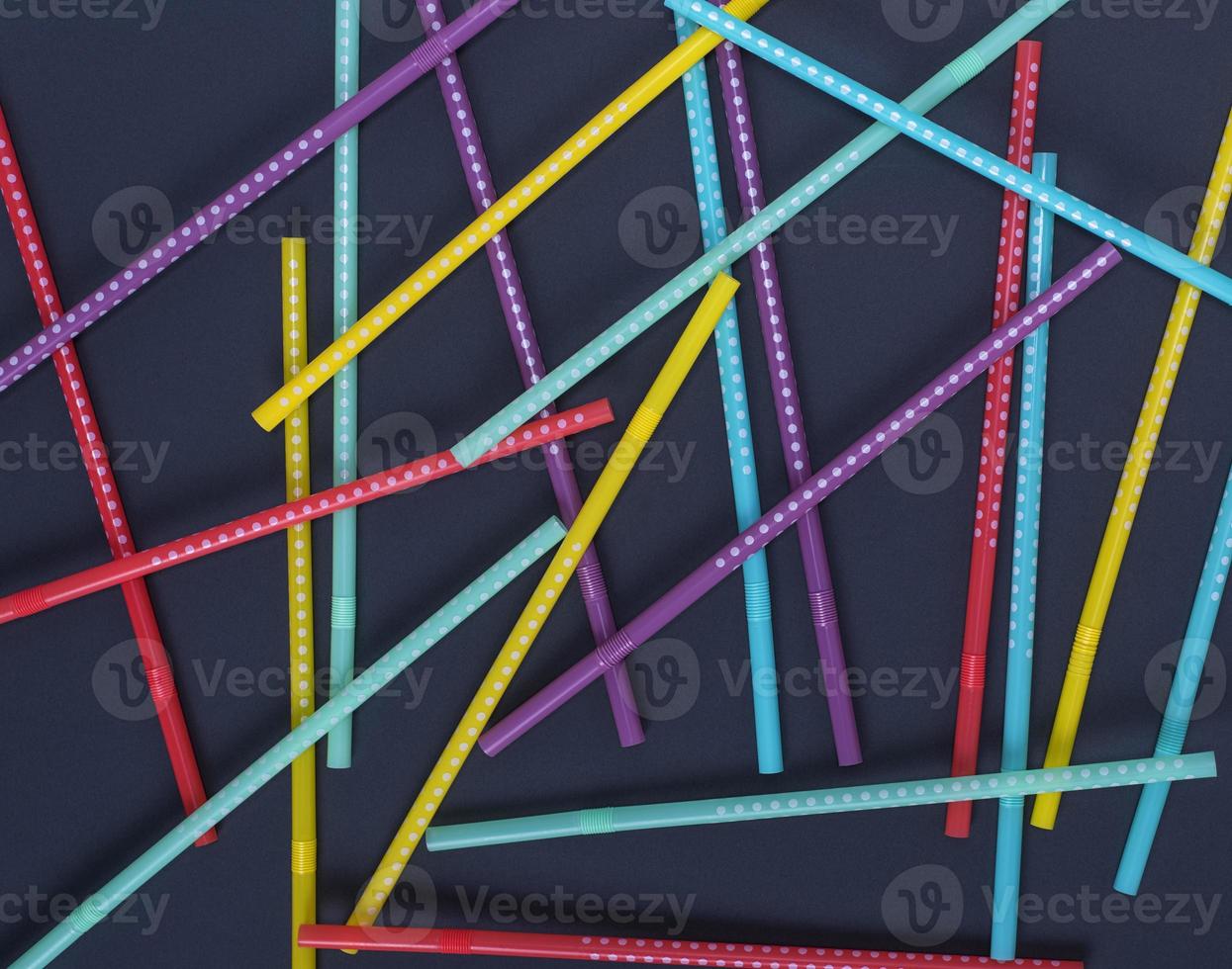 multi-colored plastic tubes in a white polka-dot for drinks photo