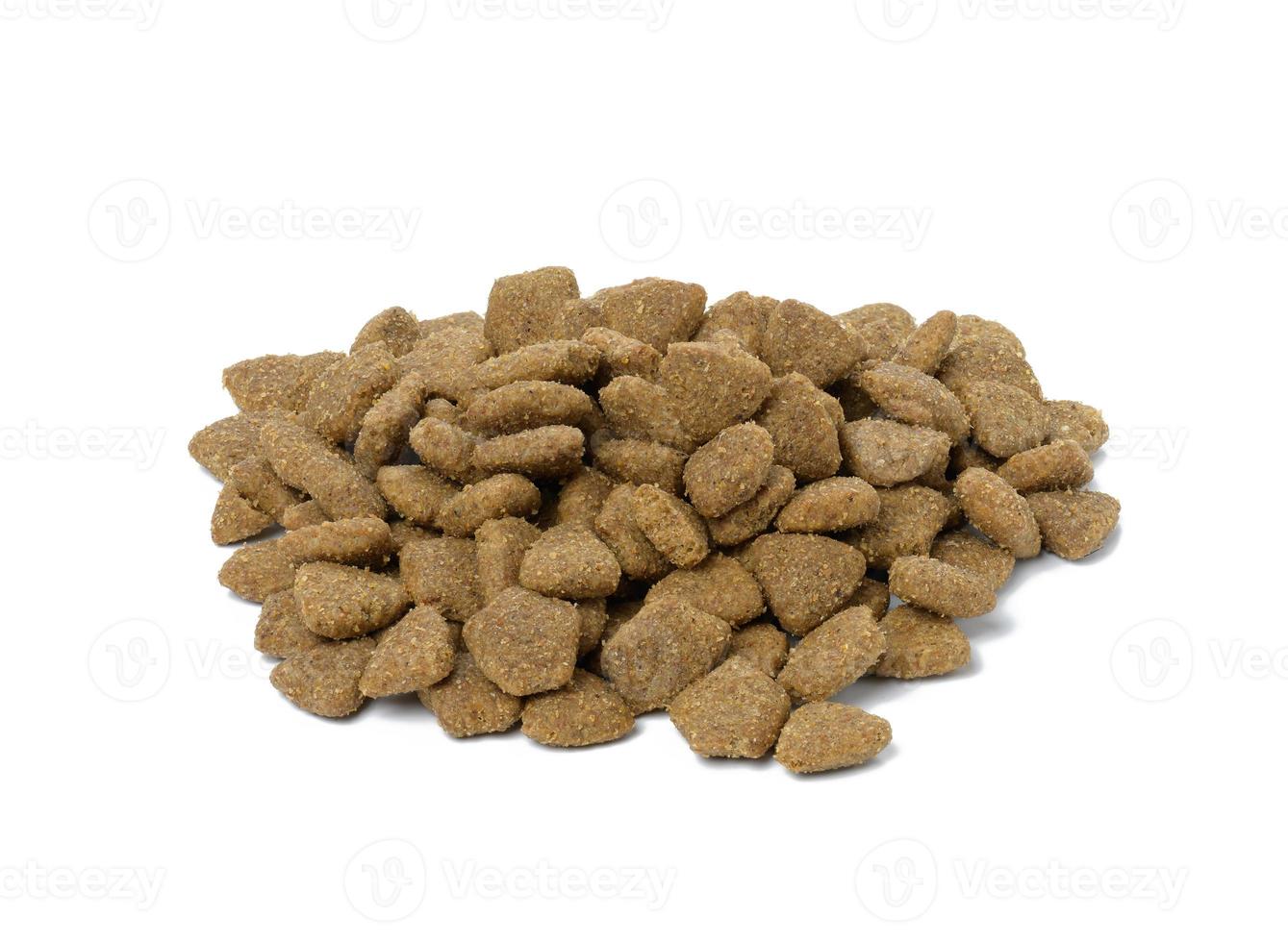 triangular pieces of animal food on a white background. Pile of nutritious food photo