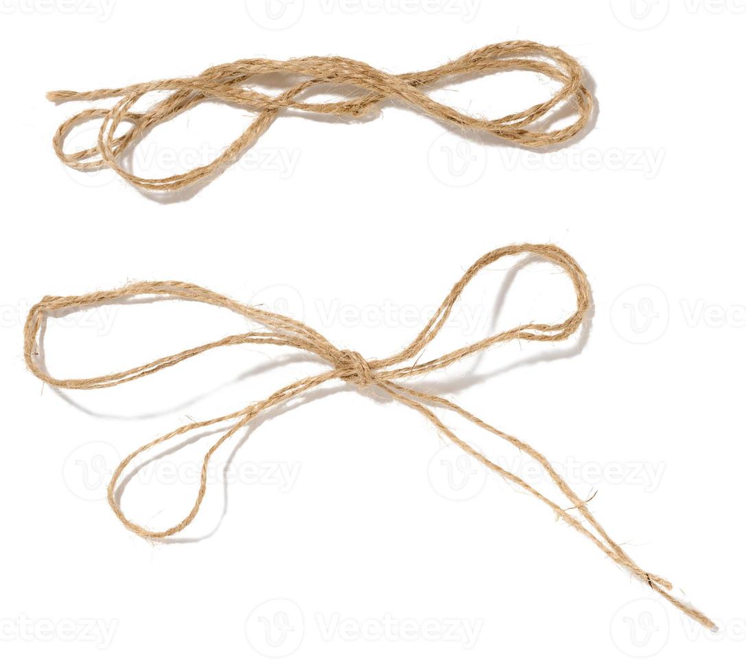 A skein of brown twine rope on a white isolated background, top view. Packing natural photo