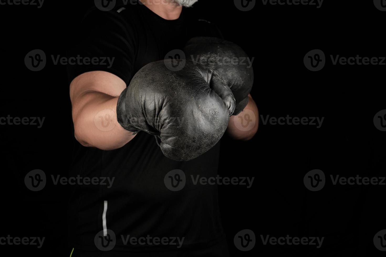 young man stands in a boxing rack photo