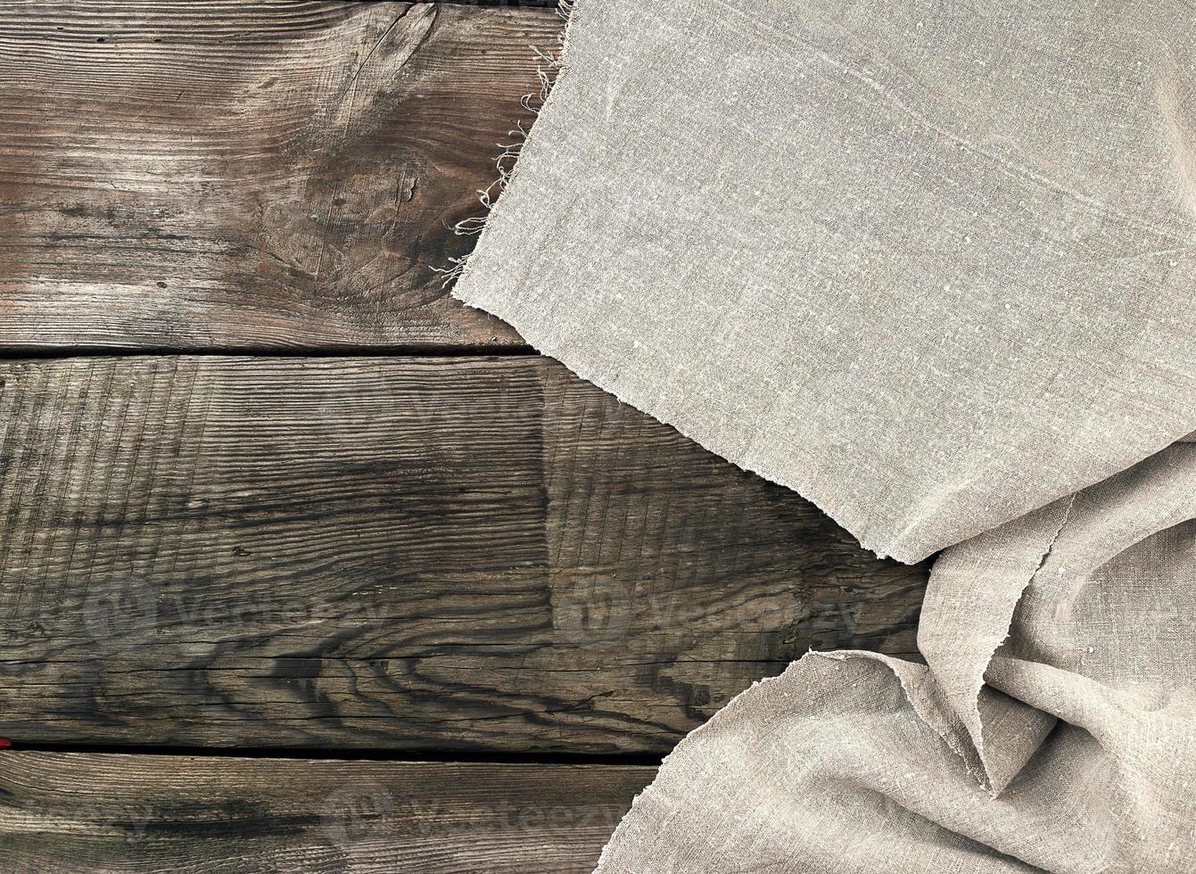 gray kitchen textile towel folded on a gray wooden table from old boards photo