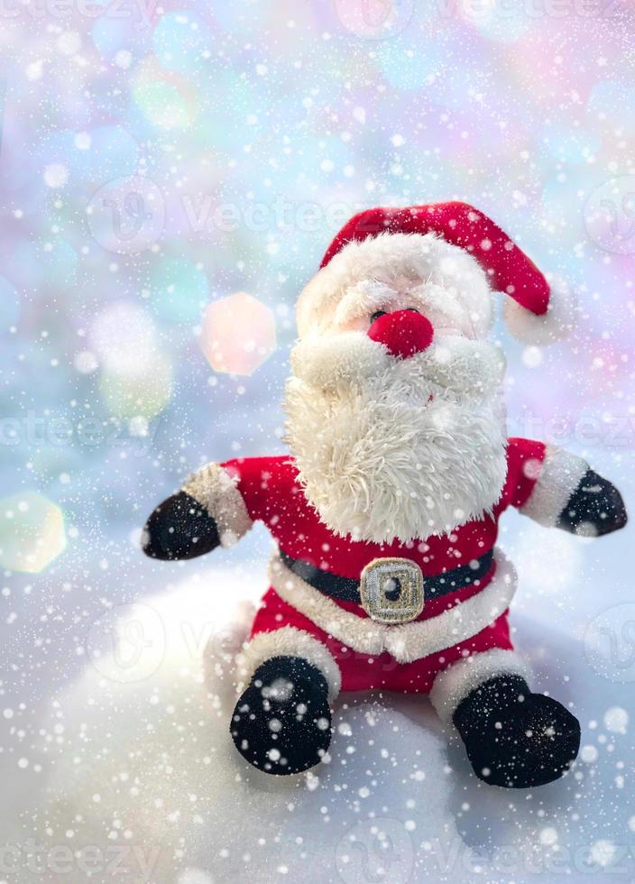 Textile Santa Claus sitting on a snow bank photo
