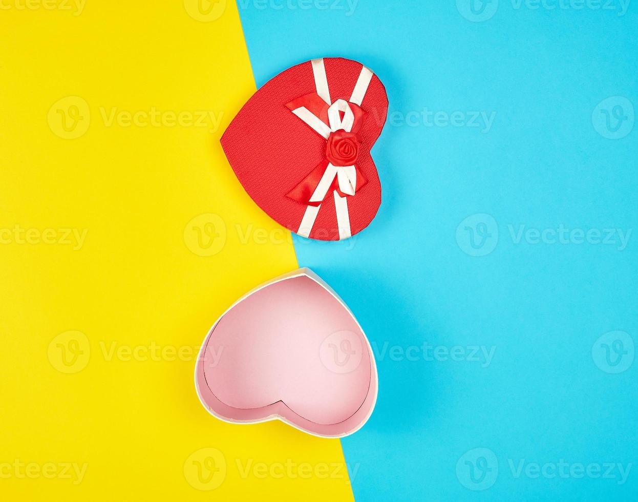 open red heart-shaped gift box with a bow photo