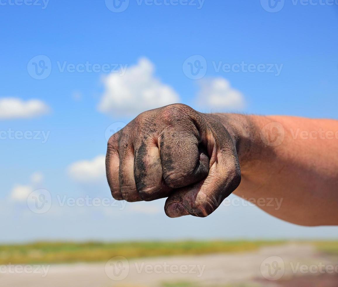 The man's hand is fisted photo